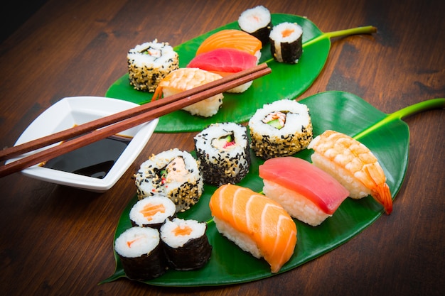 mixed sushi on green leaf