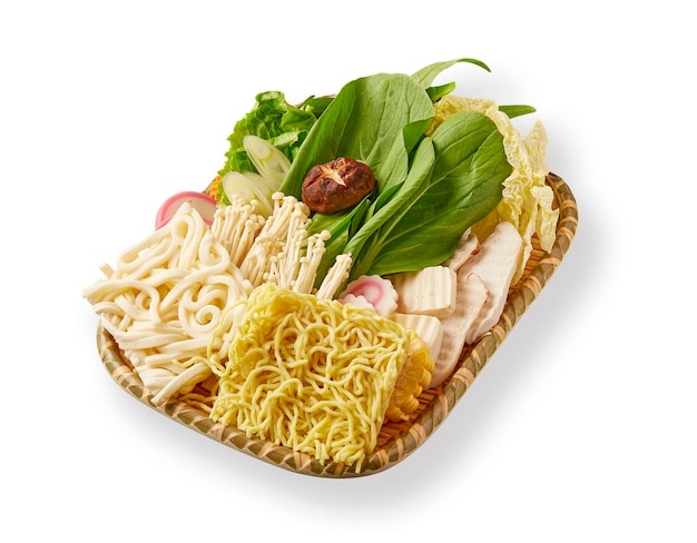 Mixed vegetables fish balls Kamaboko instant noodles and Frozen ramen noodle plate on plate isolated on white background Vegetable set for shabu