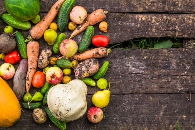 Mixed vegetables and fruits on a wooden board. 