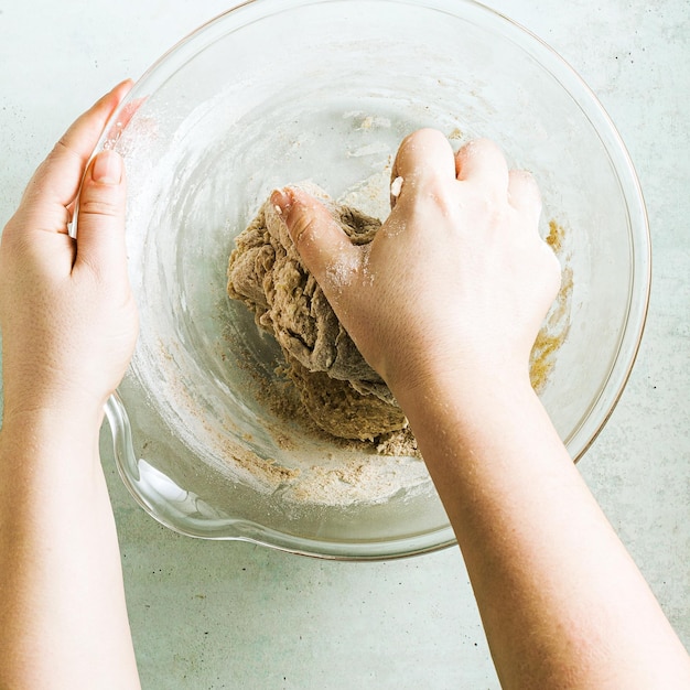 Mixing dough for chocolate cake in a bowl female hands and a kitchen whisk recipe step by step