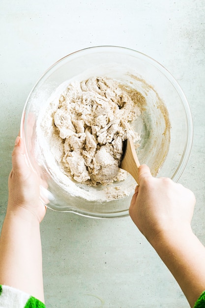 Mixing dough for chocolate cake in a bowl.