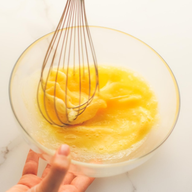 Mixing eggs in bowl on marble table homemade food recipe