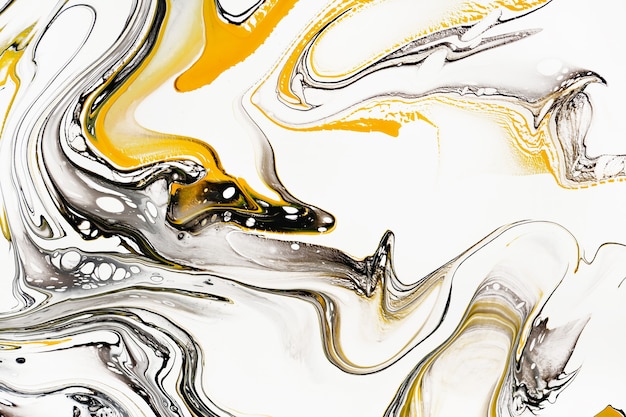 Mixture of acrylic paints. Modern artwork. Yellow and black mixed acrylic paints. Liquid marble texture. 