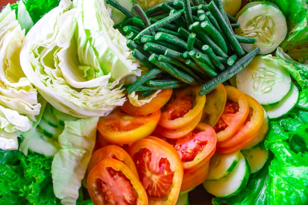 a mixture of healthy salad vegetables fresh cucumbers cabbage tomatoes long beans or Yardlong bean Diet menu Top view flat lay