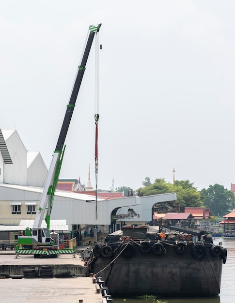 Mobile crane on dock and barges