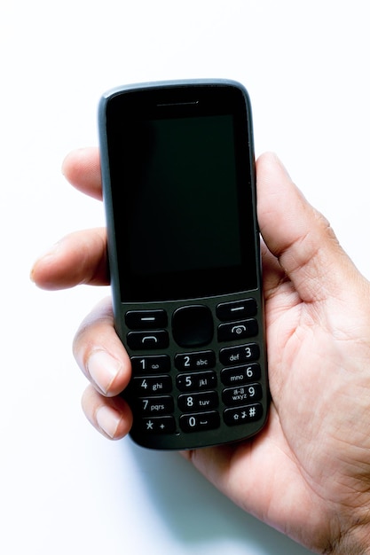 mobile phone in human hand isolated on a white background,human hand holding a simple mobile phone