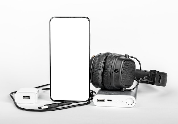 Mobile phone screen mockup smartphone display mock up with stuff for travel Headphones portable charger cords wires