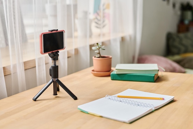 Mobile phone on tripod for online studying