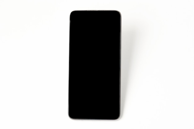 Mobile phone with black screen on white background with copy space. Smartphone mockup blank screen isolated with clipping path