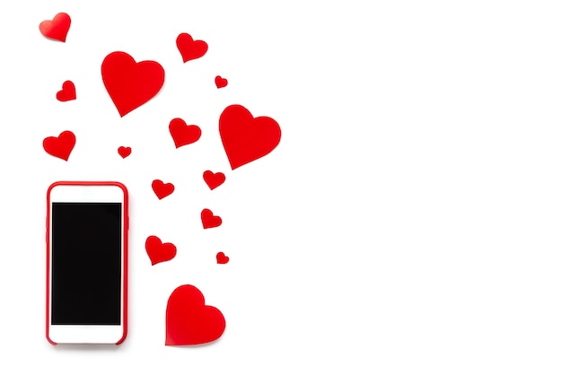 Mobile phone with red hearts like likes on a white background.