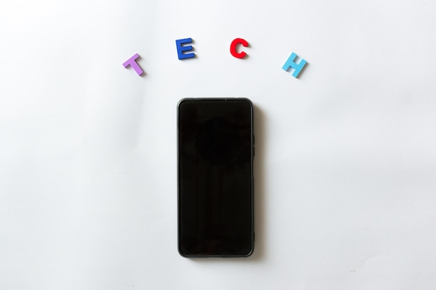 A mobile phone with the word tech in colored letters on white background