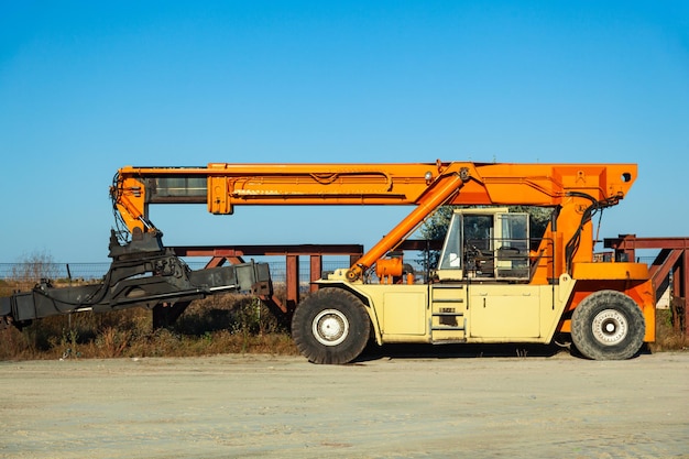 Mobile wheeled truck crane on four wheels for the transportation of sea containers