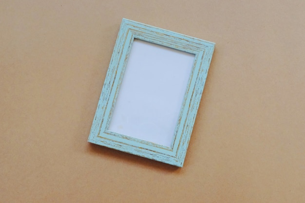 Mock up of blank photo frame on light brown background, simple and minimal style.