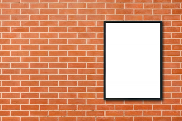 Photo mock up blank poster picture frame hanging on red brick wall background in room - can be used mock up for montage products display and design key visual layout. mock up poster in interior background.