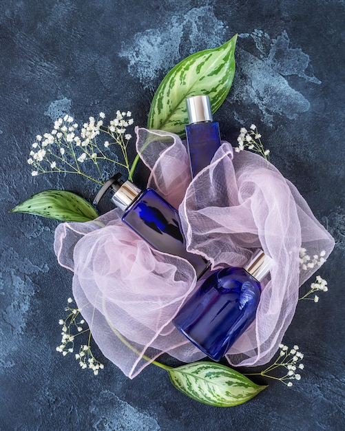 Mock up for bottles with men cosmetics based on natural and organic ingredients on blue background