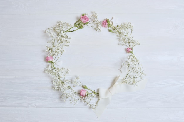 Mock up Composition wreath of white flowers rustic style, for St. Valentine's Day with a place for your text. Flat lay, top view photo mock up.