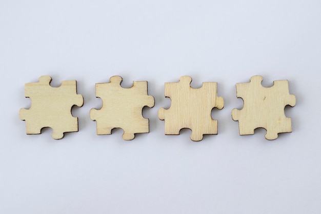 Mock up of four blank wooden puzzles on a white background for your abbreviation text or design