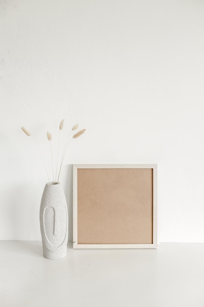 Mock up frame and dry plant on modern aesthetic vase Home interior background in warm tone