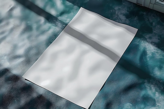 Photo mock up of a sheet of white a4 paper on a blue surface