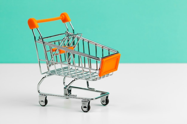 Mock up shoppong online cart on desk table office soft blue wall