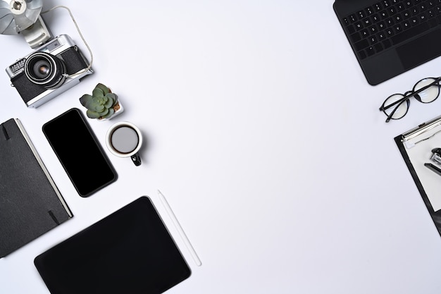 Mock up smart phone, tablet, camera and notebook on white background.