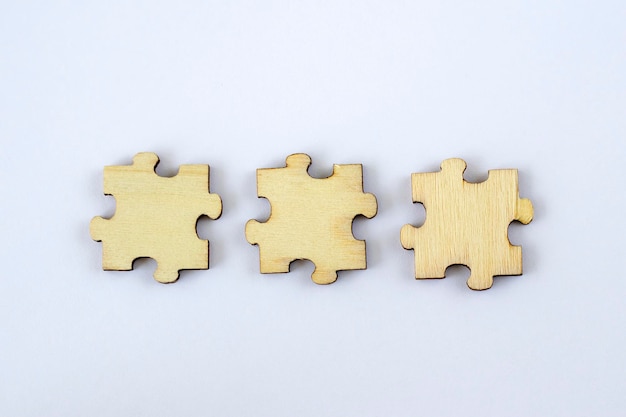 Mock up of three blank wooden puzzles on a white background for your abbreviation text or design