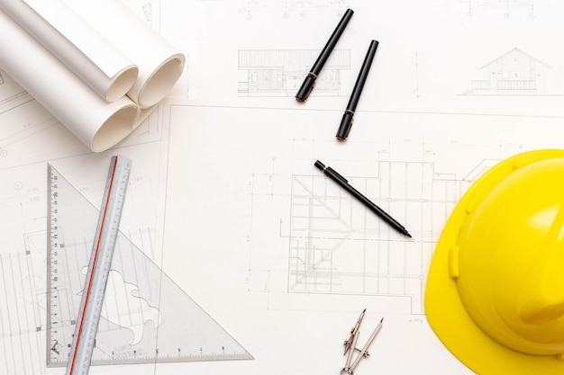 Mockup of architectural concept Drawing tools and engineer drawing on blueprint with safety helmet