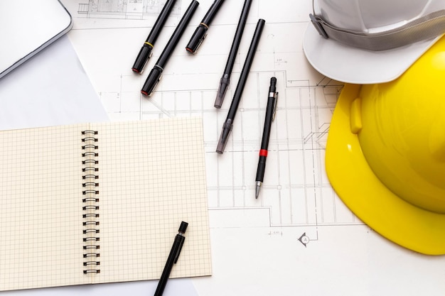 Mockup of architectural concept Drawing tools and safety helmet on engineer drawing of blueprint