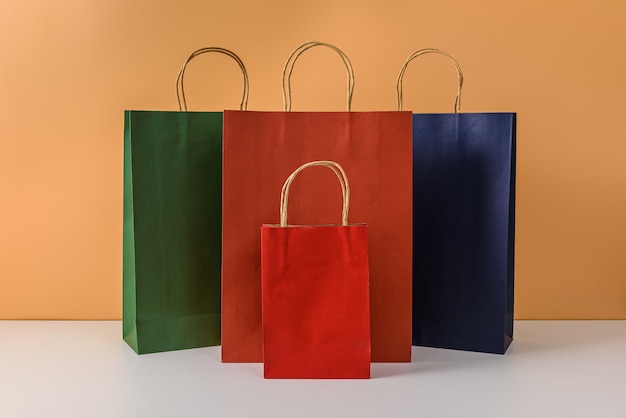 Mockup of blank craft package or colorful paper shopping bag with handles