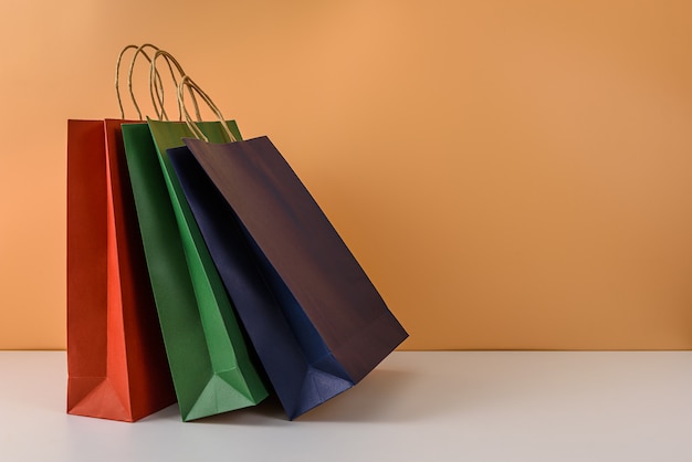 Mockup of blank craft package or colorful paper shopping bag with handles