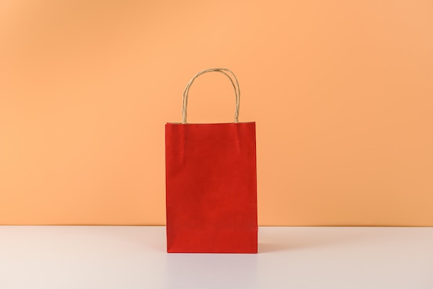 Mockup of blank craft package or colorful paper shopping bag with handles