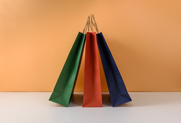 Mockup of blank craft package or colorful paper shopping bag with handles