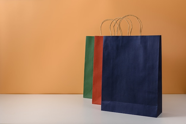 Mockup of blank craft package or colorful paper shopping bag with handles