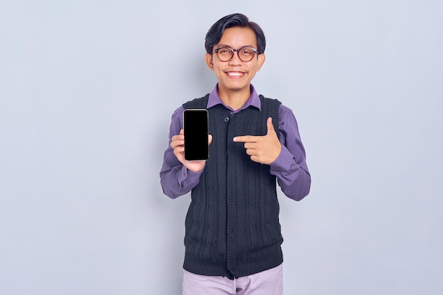 Mockup blank screen cellphone Cheerful young Asian man in casual shirt showing mobile phone with blank screen recommending mobile app isolated on white background People lifestyle concept