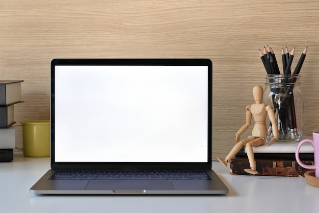 Mockup Blank screen laptop and office supplies on white table.