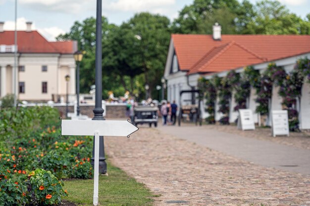 Mockup of blank sign on defocused background of historic manor courtyard