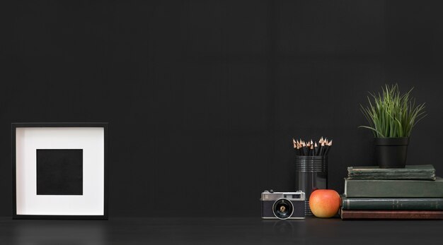 Photo mockup blank wooden picture frame and decoration objects on black background.