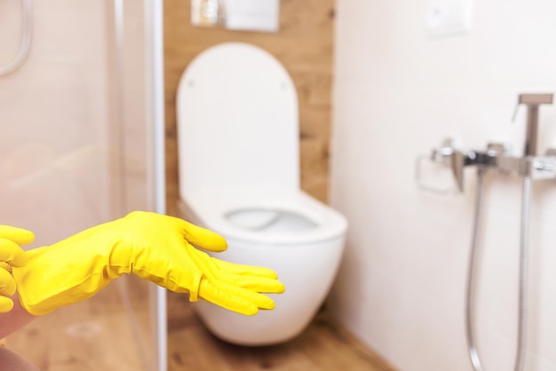 Mockup for a bottle of product hands in glove on the background of the bathroom