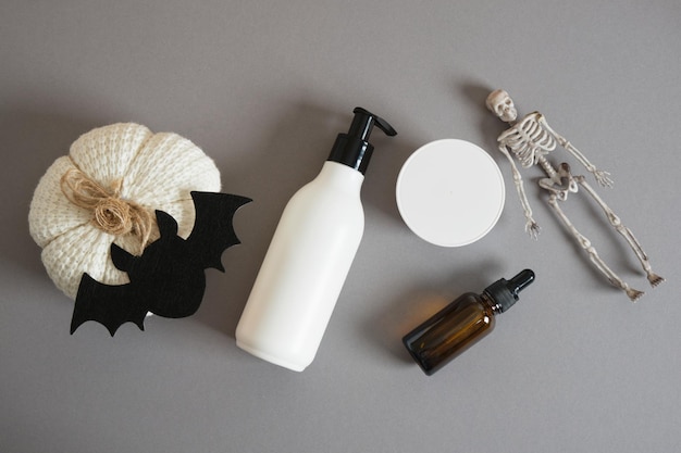 Mockup bottle with dispenser jar of cream amber glass bottle with pipette pumpkin skeleton bat