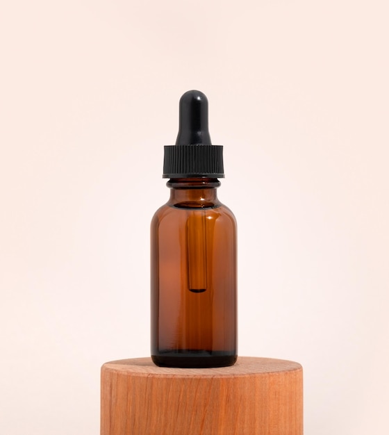 Mockup cosmetic face serum brown glass bottle with a pipette on a stylish minimalist