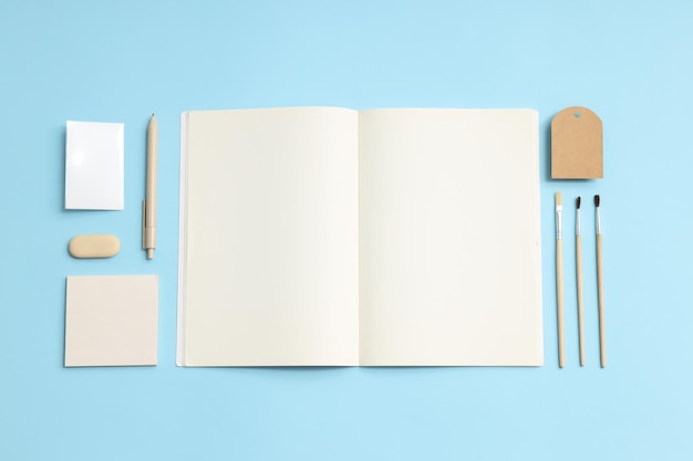 Mockup flat lay with different office accessories on blue background