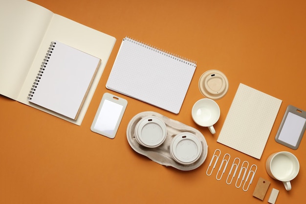 Mockup flat lay with different office accessories on brown background