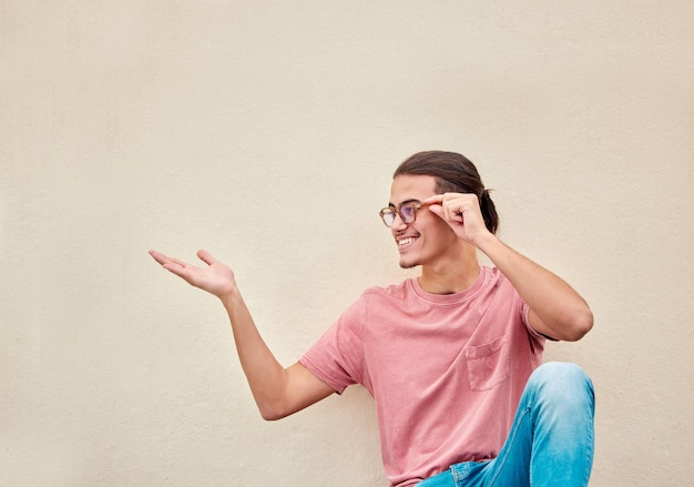 Mockup hands and happy man pointing to space for advertising empty and grey wall background Hand gesture and guy relax content and smile in studio for product placement marketing and copy space