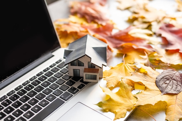 Mockup of house on background of autumn forest. Ecological housing