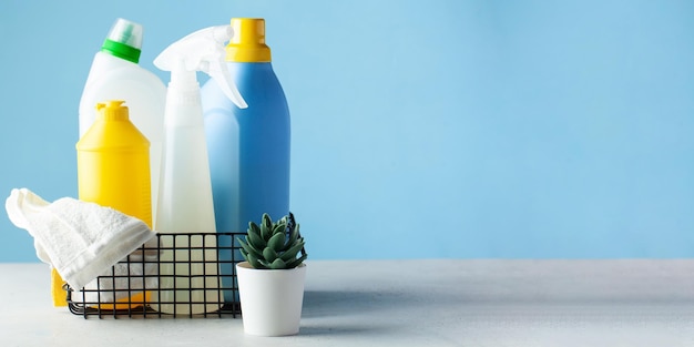 Mockup of household detergents in a metal basket on a light blue background