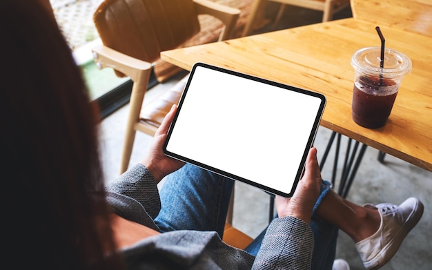 Mockup image of a woman holding digital tablet with blank white desktop screen