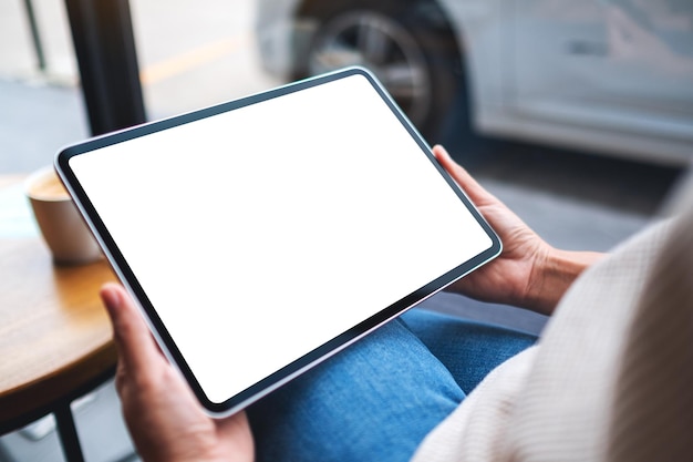 Mockup image of a woman holding digital tablet with blank white desktop screen