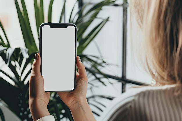 Photo mockup image of a woman holding mobile phone with blank desktop screen