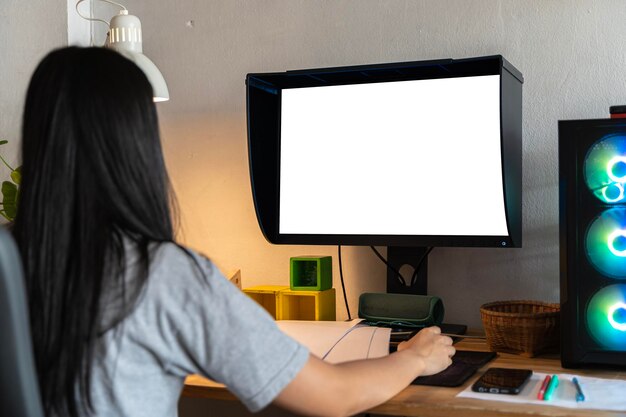 Mockup image of a woman using desktop computer with blank screen on wooden table Female writer keyboarding