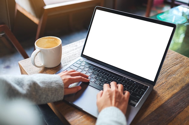 Mockup image of a woman using and typing on laptop computer keyboard with blank white desktop screen